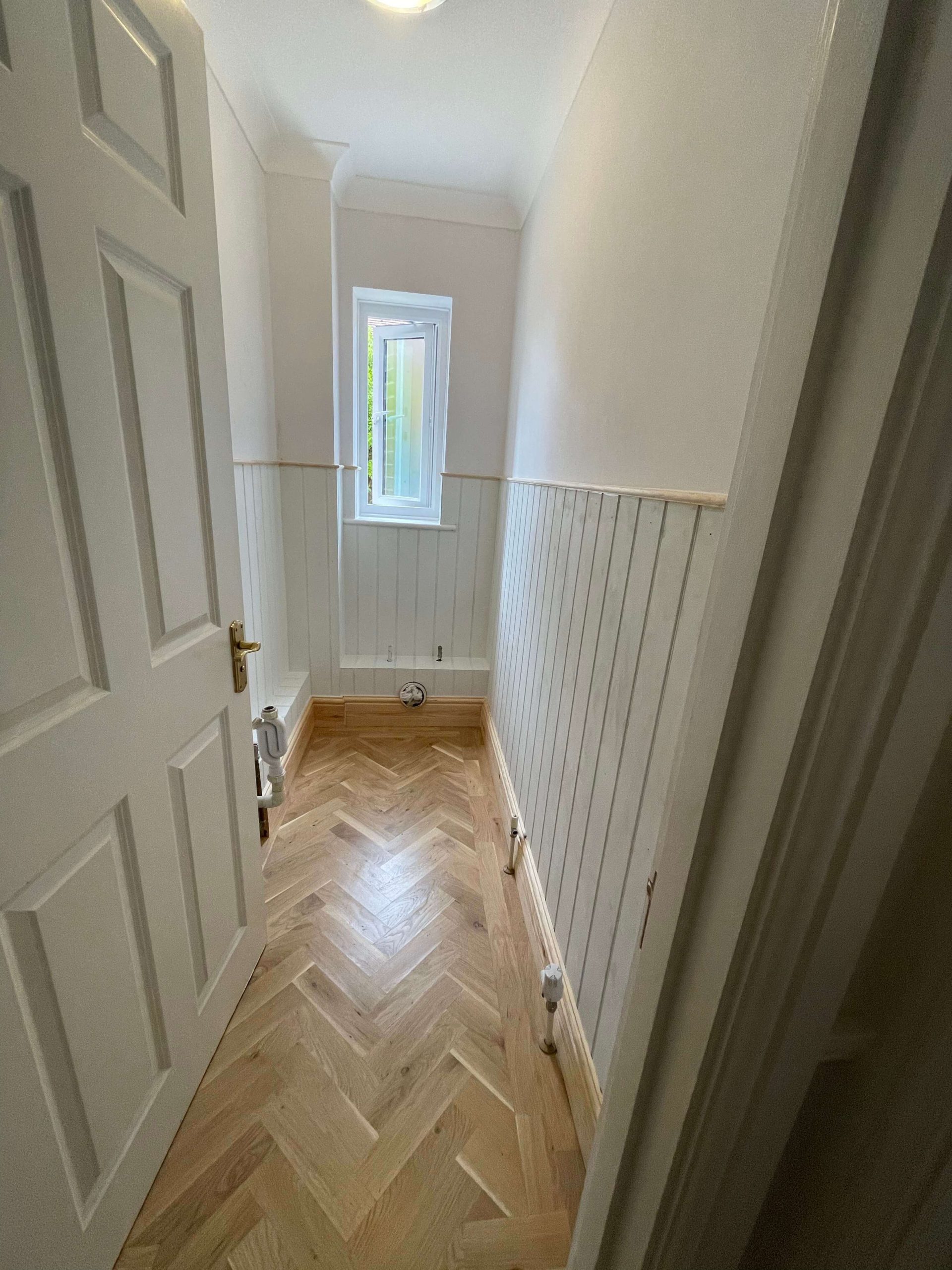 Home Hallway with an oak plank door set into an exposed timber frame, with oak flooring and skirting