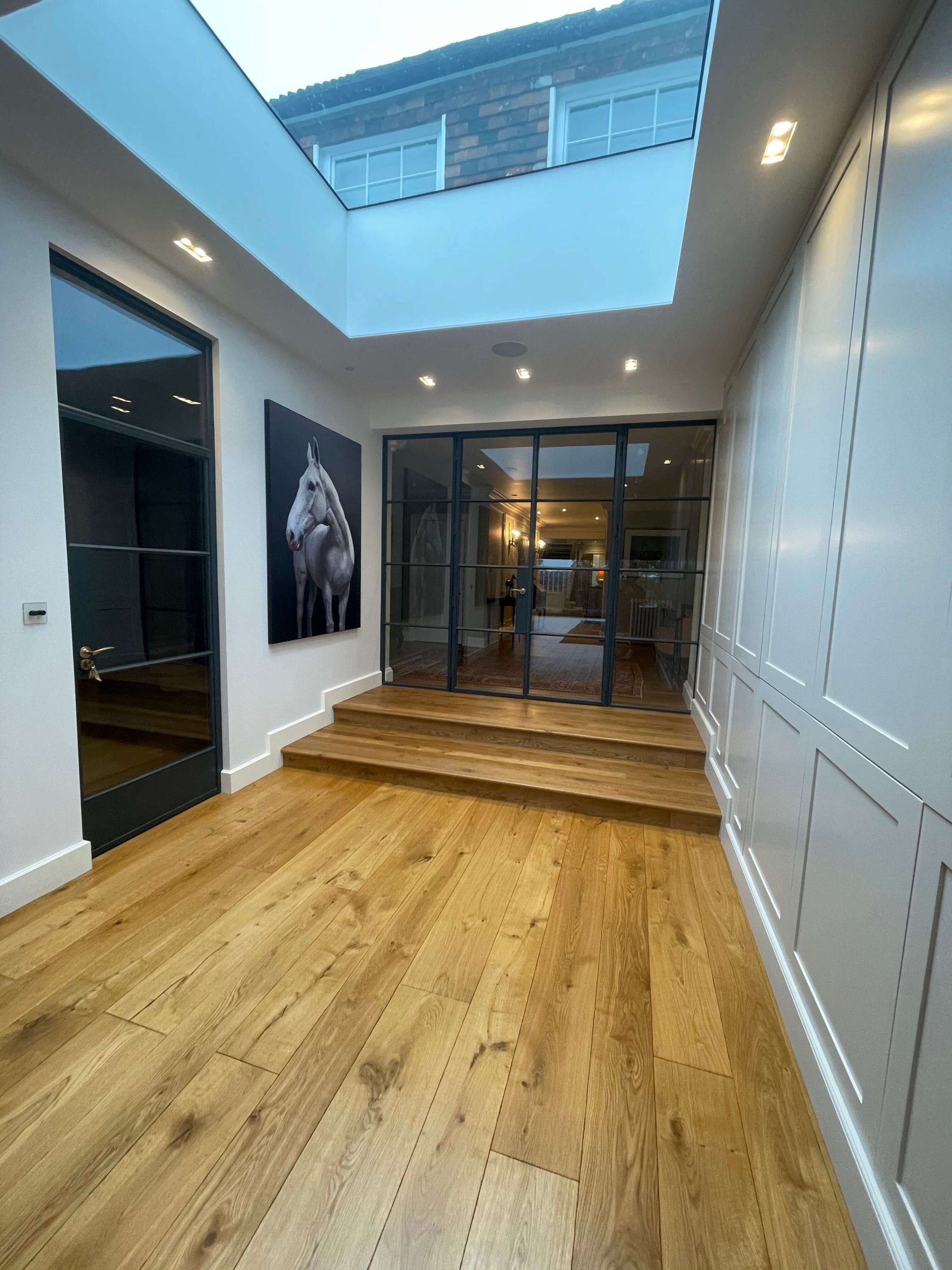 Services Hallway with a roof lantern, steel-framed glazed doors and wide oak floorboards
