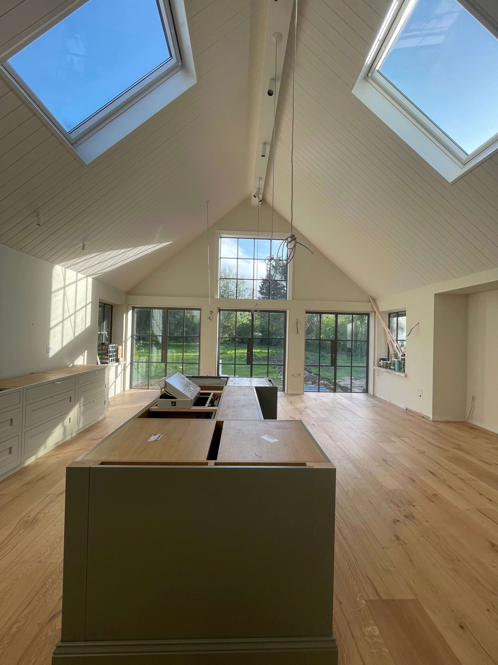 Home Vaulted room with panelled ceiling, roof light and full-height glazing overlooking the garden